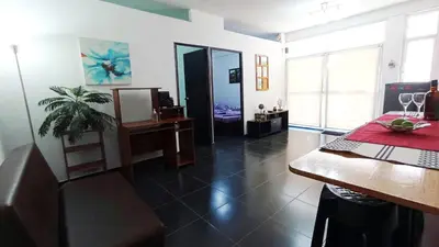 a living room with a desk and a table with a laptop at Apartamento Aeromar, Santa Marta in Santa Marta