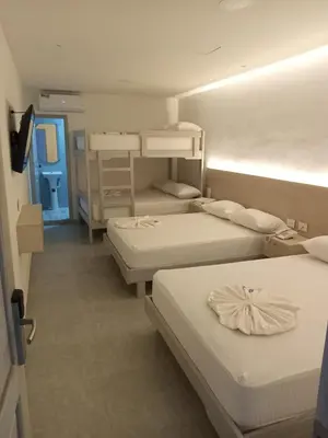 a room with three bunk beds and a hallway at Hotel San Sebastian Real in Cartagena de Indias