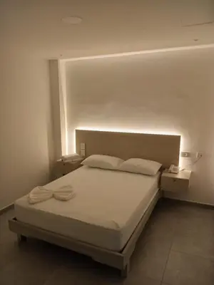 a bedroom with a bed with a light on the wall at Hotel San Sebastian Real in Cartagena de Indias
