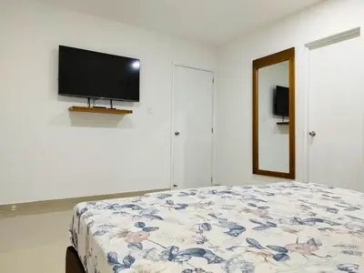 a bedroom with a bed and a flat screen tv at Morros Epic in Cartagena de Indias