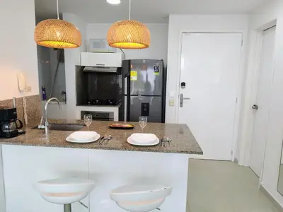 a kitchen with two white plates and two glasses on a counter at Morros Epic in Cartagena de Indias