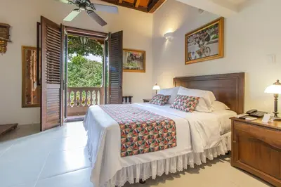 a bedroom with a bed and a balcony at Hotel Casa La Fe in Cartagena de Indias