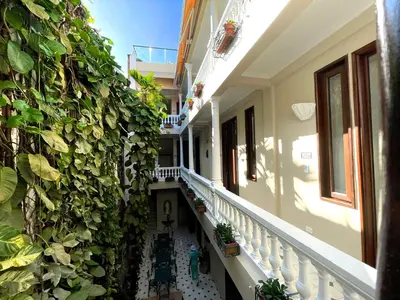 a hallway of a building with plants on the wall at Hotel Casa La Fe in Cartagena de Indias