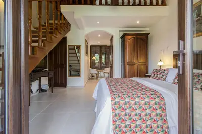 a bedroom with a bed and a staircase at Hotel Casa La Fe in Cartagena de Indias