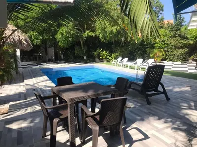 a patio with a table and chairs next to a pool at Carmela Beach in Tubará