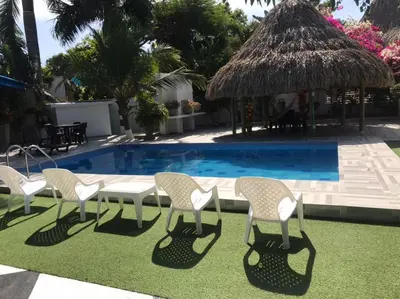 a group of chairs and a table by a pool at Carmela Beach in Tubará