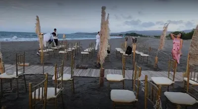 a group of chairs and tables on a beach at Carmela Beach in Tubará