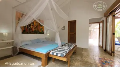 a bedroom with a bed with a canopy at Casa de Playa Moñitos Laguito in Moñitos
