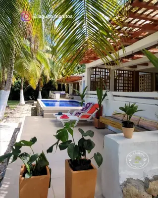 a patio with a pool and a bunch of plants at Casa de Playa Moñitos Laguito in Moñitos