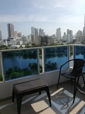 a balcony with chairs and a view of the city at Apartamentos Cartagena in Cartagena de Indias