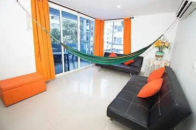 a living room with a hammock and a couch at Apartamentos Cartagena in Cartagena de Indias