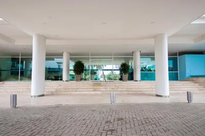 a large building with white columns and blue walls at Morros con acceso directo a la playa in Cartagena de Indias