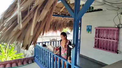 a woman walking on a blue railing at Milimar Hostal in San Onofre