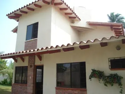 a large white house with a roof at Cabaña Coveñas in Coveñas