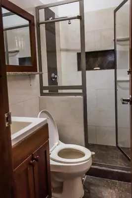 a bathroom with a toilet and a sink and a shower at Cabaña Coveñas in Coveñas
