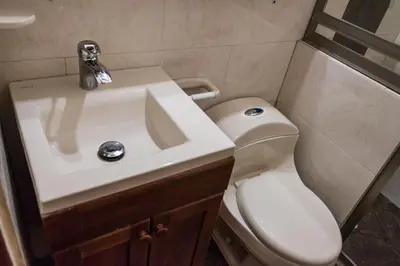a bathroom with a white sink and a toilet at Cabaña Coveñas in Coveñas