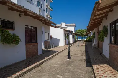 a street with white buildings and a street light on a sidewalk at Cabaña Coveñas in Coveñas