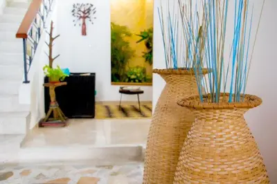 two large wicker vases sitting in a room at Hotel Iraka Zenu in Sincelejo
