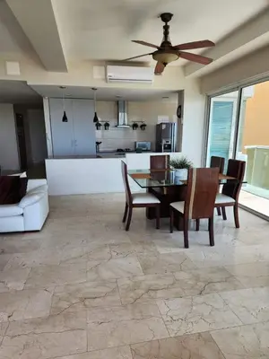 a living room with a ceiling fan and a table and chairs at Cartagena la Boquilla amobaldo vista directa al mar a pocos pasos de playa in Santa Barbará