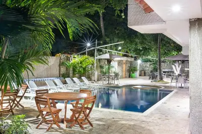 a patio with a table and chairs and a pool at Santorini Villas Santa Marta in Santa Marta