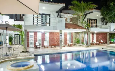 a swimming pool in front of a house at Santorini Villas Santa Marta in Santa Marta