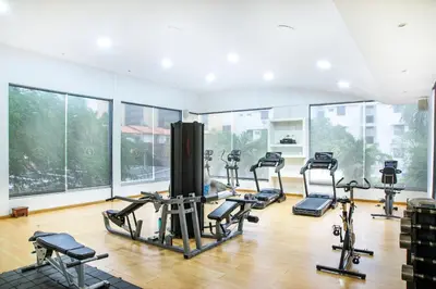 a gym with several treadmills and exercise bikes at Hotel Santorini Resort in Santa Marta