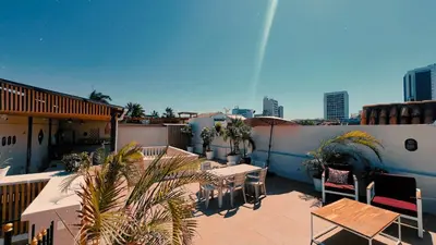 a patio with tables and chairs on a roof at Viajero Cartagena - Centro Hostel in Cartagena de Indias