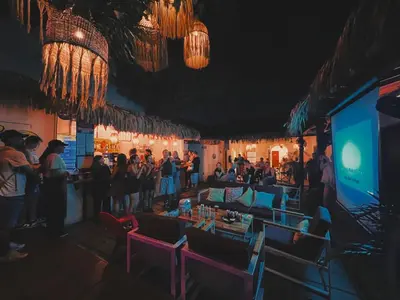a crowd of people standing around a bar at night at Viajero Cartagena - Centro Hostel in Cartagena de Indias