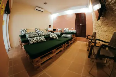 a room with a row of benches with pillows at Viajero Cartagena - Centro Hostel in Cartagena de Indias
