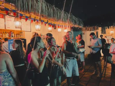 a group of people standing in a bar at Viajero Cartagena - Centro Hostel in Cartagena de Indias