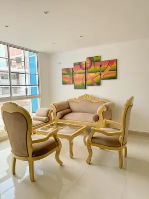 a living room with a couch and two chairs at Hotel Ginebra Sincelejo in Sincelejo