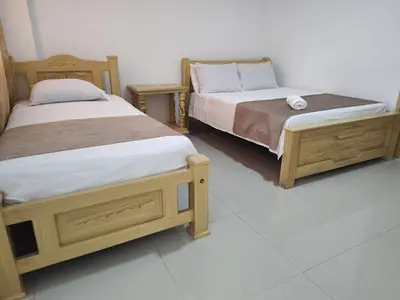 two beds sitting next to each other in a room at Hotel Ginebra Sincelejo in Sincelejo