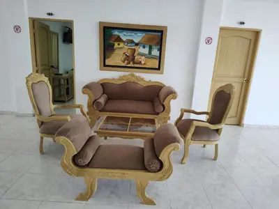 a living room with a couch and two chairs at Hotel Ginebra Sincelejo in Sincelejo