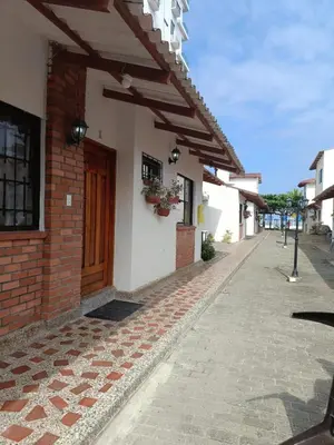 a brick building with a door on a street at Espectacular cabaña en Coveñas - Sucre, Frente al mar!!! in Coveñas