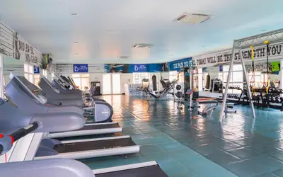 a gym with treadmills and machines in a room at Hotel Dann Carlton Barranquilla y Centro de Convenciones in Barranquilla