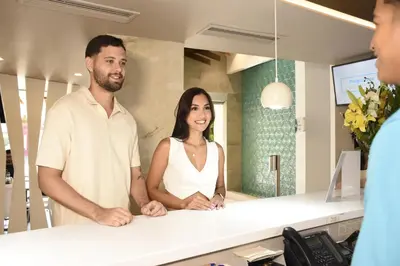 a man and a woman standing in front of a counter at Hotel Barlovento in Cartagena de Indias