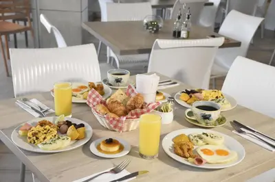 a table with plates of breakfast food on it at Hotel Barlovento in Cartagena de Indias