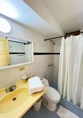 a bathroom with a sink and a toilet at Hotel Casa Ballesteros in Barranquilla