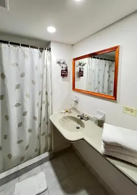 a bathroom with a sink and a shower at Hotel Casa Ballesteros in Barranquilla