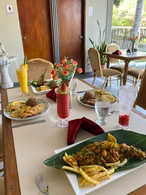 a table with several plates of food on it at Hotel Casa Ballesteros in Barranquilla