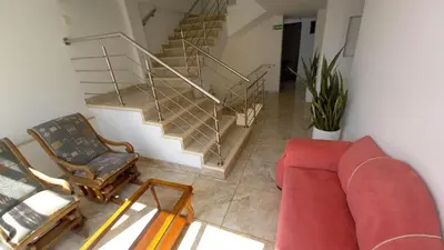 a living room with a couch and a stair case at Perla De La Sabana in Corozal