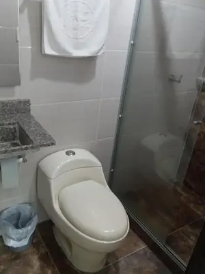 a bathroom with a toilet and a shower at Perla De La Sabana in Corozal