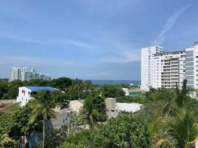 a view of a city with palm trees and buildings at Hotel West Plaza in Santa Marta