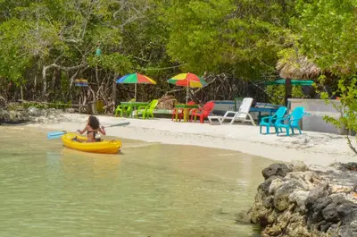 a little girl in a yellow raft in the water at Hotel Puntanorte in Tintipan Island