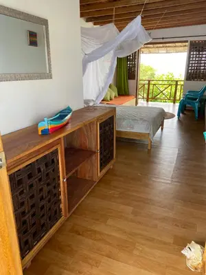 a room with a bed and a table in a room at Hotel Puntanorte in Tintipan Island
