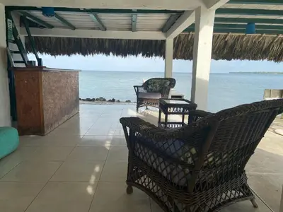 a porch with chairs and a view of the ocean at Hotel Puntanorte in Tintipan Island