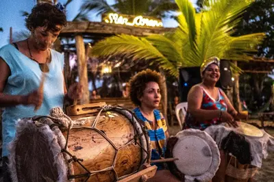 a group of people standing next to a barrel at Mar Amar Casa de Playa in Coveñas
