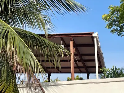 a building with palm trees in front of it at Hotel Casa de Las Palmas in Cartagena de Indias