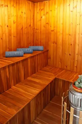 a sauna with wooden paneled walls and wooden shelves at Estelar Apartamentos Barranquilla in Barranquilla