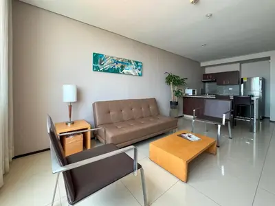 a living room with a couch and a table at Estelar Apartamentos Barranquilla in Barranquilla